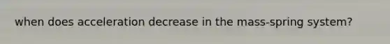 when does acceleration decrease in the mass-spring system?
