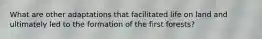 What are other adaptations that facilitated life on land and ultimately led to the formation of the first forests?
