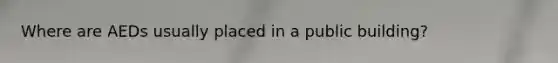 Where are AEDs usually placed in a public building?