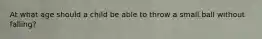 At what age should a child be able to throw a small ball without falling?