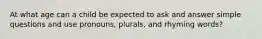 At what age can a child be expected to ask and answer simple questions and use pronouns, plurals, and rhyming words?