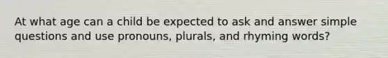 At what age can a child be expected to ask and answer simple questions and use pronouns, plurals, and rhyming words?