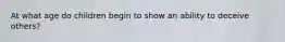 At what age do children begin to show an ability to deceive others?