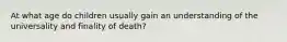 At what age do children usually gain an understanding of the universality and finality of death?