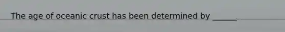 The age of oceanic crust has been determined by ______
