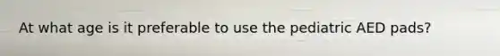 At what age is it preferable to use the pediatric AED pads?