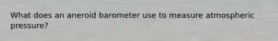 What does an aneroid barometer use to measure atmospheric pressure?