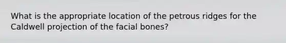 What is the appropriate location of the petrous ridges for the Caldwell projection of the facial bones?