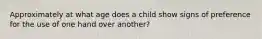 Approximately at what age does a child show signs of preference for the use of one hand over another?