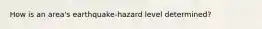 How is an area's earthquake-hazard level determined?