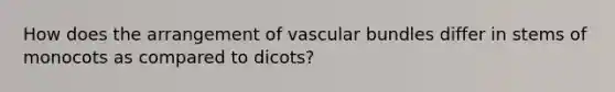 How does the arrangement of vascular bundles differ in stems of monocots as compared to dicots?