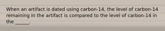 When an artifact is dated using carbon-14, the level of carbon-14 remaining in the artifact is compared to the level of carbon-14 in the ______.