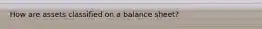 How are assets classified on a balance sheet?