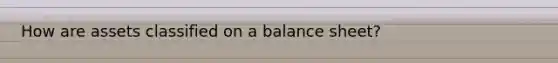 How are assets classified on a balance sheet?