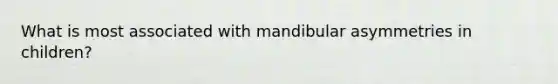 What is most associated with mandibular asymmetries in children?