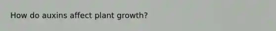 How do auxins affect plant growth?