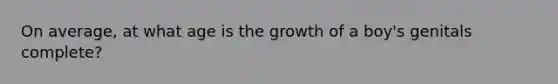 On average, at what age is the growth of a boy's genitals complete?