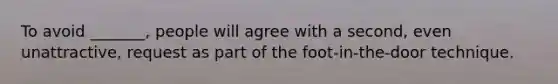 To avoid _______, people will agree with a second, even unattractive, request as part of the foot-in-the-door technique.