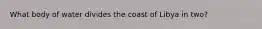 What body of water divides the coast of Libya in two?