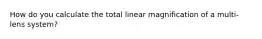 How do you calculate the total linear magnification of a multi-lens system?