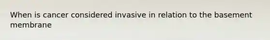 When is cancer considered invasive in relation to the basement membrane