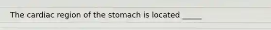 The cardiac region of the stomach is located _____