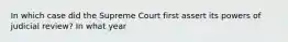 In which case did the Supreme Court first assert its powers of judicial review? In what year