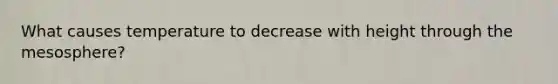 What causes temperature to decrease with height through the mesosphere?