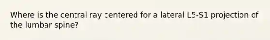 Where is the central ray centered for a lateral L5-S1 projection of the lumbar spine?
