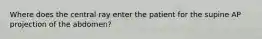 Where does the central ray enter the patient for the supine AP projection of the abdomen?