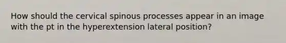 How should the cervical spinous processes appear in an image with the pt in the hyperextension lateral position?