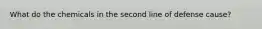 What do the chemicals in the second line of defense cause?