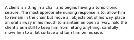 A client is sitting in a chair and begins having a tonic-clonic seizure. The most appropriate nursing response is to: allow him to remain in the chair but move all objects out of his way. place an oral airway in his mouth to maintain an open airway. hold the client's arm still to keep him from hitting anything. carefully move him to a <a href='https://www.questionai.com/knowledge/kOWiejdjxQ-flat-surface' class='anchor-knowledge'>flat surface</a> and turn him on his side.