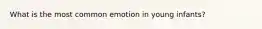 What is the most common emotion in young infants?
