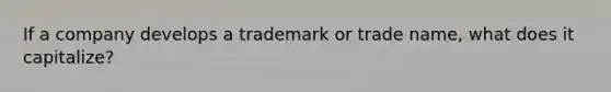 If a company develops a trademark or trade name, what does it capitalize?