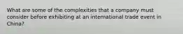 What are some of the complexities that a company must consider before exhibiting at an international trade event in China?