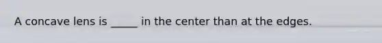 A concave lens is _____ in the center than at the edges.