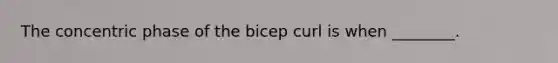 The concentric phase of the bicep curl is when ________.