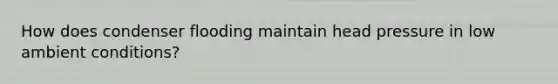 How does condenser flooding maintain head pressure in low ambient conditions?