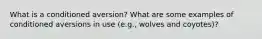 What is a conditioned aversion? What are some examples of conditioned aversions in use (e.g., wolves and coyotes)?