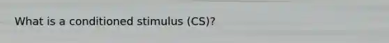 What is a conditioned stimulus (CS)?