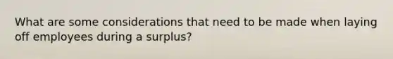 What are some considerations that need to be made when laying off employees during a surplus?