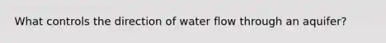 What controls the direction of water flow through an aquifer?