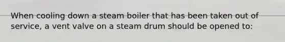 When cooling down a steam boiler that has been taken out of service, a vent valve on a steam drum should be opened to: