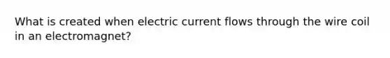 What is created when electric current flows through the wire coil in an electromagnet?