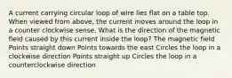 A current carrying circular loop of wire lies flat on a table top. When viewed from above, the current moves around the loop in a counter clockwise sense. What is the direction of the magnetic field caused by this current inside the loop? The magnetic field Points straight down Points towards the east Circles the loop in a clockwise direction Points straight up Circles the loop in a counterclockwise direction