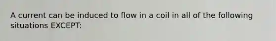 A current can be induced to flow in a coil in all of the following situations EXCEPT: