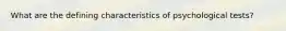 What are the defining characteristics of psychological tests?