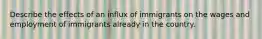 Describe the effects of an influx of immigrants on the wages and employment of immigrants already in the country.