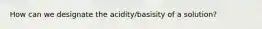 How can we designate the acidity/basisity of a solution?